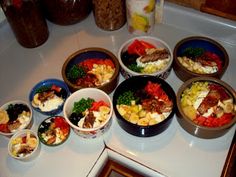 several bowls filled with different types of food