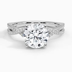 a round cut diamond ring with pave set shoulders