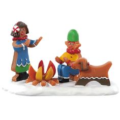 two figurines sitting on top of a snow covered ground