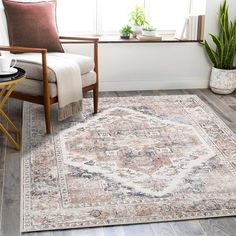 a living room area with a chair, rug and potted plant in the corner