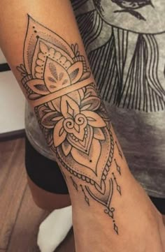 a woman's arm with a tattoo on it and a flower in the middle