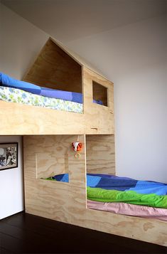 the bunk bed is made from plywood and has two sets of stairs on each side