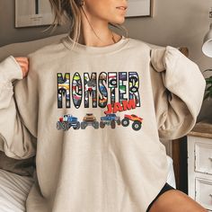 Momster Jam Monster Truck Shirts- This Cozy Boy Mama Sweatshirt  with Big Monster Trucks Jam Theme is sure to be a favorite gift for mom and son. Sizes S-5X. Perfect for Monster Truck Jam events, boy baby shower gifts or new mom boy gifts, boys birthday or mom's birthday. FOR MOMSTER JAM T-SHIRTS: https://commoncode.etsy.com/listing/1633856270 FOR MOMSTER JAM COMFORT COLORS LONG SLEEVE TEES AND SHORT SLEEVE TESS: https://commoncode.etsy.com/listing/1642336069 for more Customizable Family Matchin Monster Jam Birthday Shirts Family, Monster Jam Mom Outfit, Monster Jam Shirt Ideas, Monster Truck Outfit Women, Monster Jam Birthday Shirt, Monster Jam Outfit Women, Monster Truck 3rd Birthday Party, Monster Jam Shirts, Monster Truck Jam