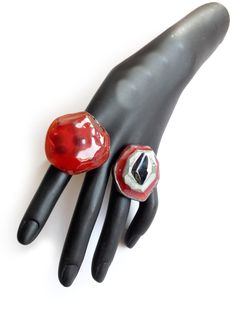 "Chunky Red Ring, Rough Ring, Irregular Ring, Red Black Ring, Resin Ring, Summer Ring, Artisan Ring, Fashion, Contemporary, Jewelry, Resin Ring. KEEP IT AWAY FROM hair spray, nail polish remover, and other chemicals. Can be washed with gentle liquid soap. ADJUSTABLE Ring Measure 5 cm X 2.5 cm = 2\" x 1\" ----------------- More Rings here https://www.etsy.com/shop/ShimmeringCloud?ref=seller-platform-mcnav&section_id=33613562" Rough Ring, Ring Resin, Summer Rings, Red Ring, Red Rings, Artisan Rings, Jewelry Resin, Black Ring, Ring Fashion