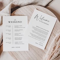 two wedding programs sitting on top of a wooden plate