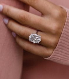 a woman's hand with a diamond ring on it