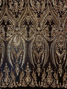 gold and black fabric with intricate designs on it