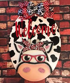 a cow with glasses and a bow on it's head that says, welcome