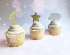 three cupcakes with frosting and stars on top