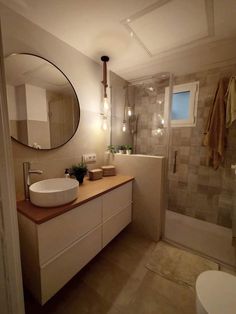 a bathroom with a sink, mirror and shower