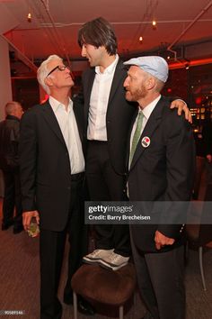 three men in suits and turbans are standing next to each other at an event