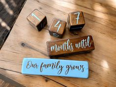 three wooden blocks with numbers on them sitting on top of a table next to each other