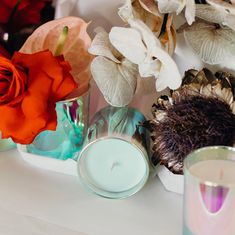 flowers and candles are sitting on a table