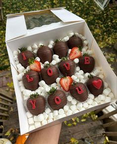 chocolate covered strawberries in a box with i love you written on them