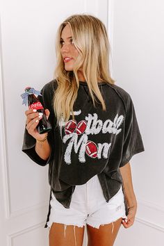 - Sparkle on the sidelines with this adorable 'FOOTBALL MOM' top! Perfect for showing your team spirit, this piece is comfy-casual style with a touch of glam. Its eye-catching design makes it a must-have for every proud football mom. - Unlined sweatshirt material with a vintage wash - A white and red hued 'FOOTBALL MOM' graphic design with rhinestone accents - Unfinished seam accents - A crew cut neckline - Short, loose sleeves - An ultra-relaxed silhouette that ends in a high-low hemline with s Football Mom Apparel, Football Mom Outfits, Cheer Mom And Football Mom Shirt, Football Mom Tank Tops, In My Football Mom Era, Football Mom Outfit, Vintage Graphic T-shirt For Football Season, Football Game Outfit Highschool, Football Mom Shirts