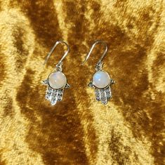 New! Colorful In Sunshine Made In India Sterling Silver Moonstone Hamsa Earrings Made In India Sterling Silver Moonstone Hamsa Earrings The Hand (Khamsa), Particularly The Open Right Hand, Is A Sign Of Protection That Also Represents Blessings, Power And Strength, And Is Seen As Potent In Deflecting The Evil Eye. Moonstone Cultivates Compassion And Empathy Towards Yourself And Others. It Helps You To Tap Into Your Intuition To Help You See Situations More Clearly. Moonstone Is Good For Activatin White Crystal Pierced Earrings As Gift, White Pierced Crystal Earrings As Gift, White Pierced Crystal Earrings For Gifts, White Spiritual Dangle Jewelry, Nickel-free Moonstone Spiritual Earrings, Spiritual White Earrings For Gift, Handmade White Crystal Round Earrings, Handmade White Crystal Earrings, Nickel-free White Crystal Earrings As Gift