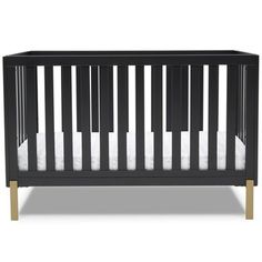 a black crib with white sheets and wood trims on the bottom, in front of a white background