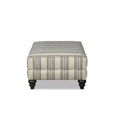 the footstool is upholstered and has striped fabric on it's sides