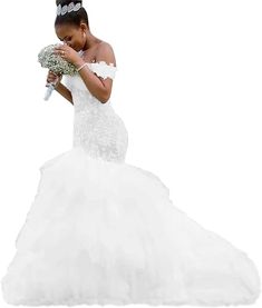 a woman in a wedding dress holding a bouquet