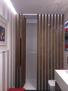 a modern bathroom with wooden slats on the wall