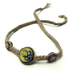 a rope bracelet with two beads and a button on the clasp that says, michigan