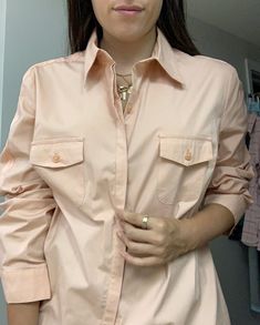 A vintage light peachy pink button down.  It is by the brand Nine Company. It fits like a size medium. Model is a size XS/S so it can fit down to that size as well.  Pristine vintage condition, it looks like it was never worn. Owned by a performer in the 50s. Thank you for supporting my small business, Shop Second Act! Classic Pink Button-up Top, Vintage Pink Shirt With Buttons, Feminine Pink Button-up Blouse, Vintage Pink Button-up Blouse, Vintage Pink Button-up Outerwear, Peachy Pink, Vintage Button, Vintage Lighting, Vintage Pink