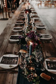 the long table is set with place settings for dinner guests to sit down and enjoy