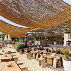 an outdoor seating area with tables and benches