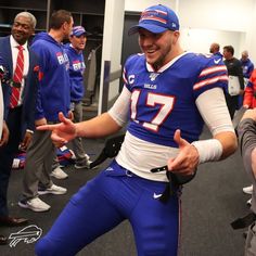 a man in a football uniform is dancing