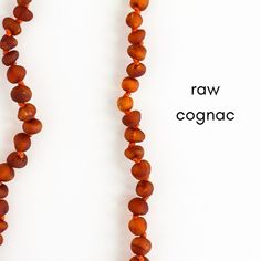 two necklaces made from raw cognac beads on a white background with the words raw coganc written below them