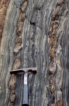 a hammer is stuck in between two large rocks