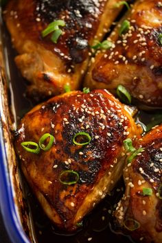 baked teriyaki chicken in a blue dish with sesame seeds