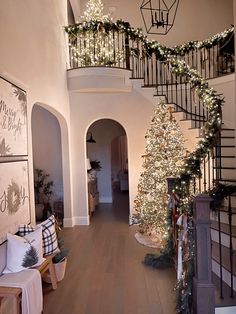 a staircase decorated with christmas lights and garland