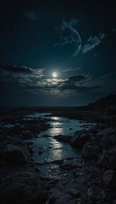 the moon shines brightly in the night sky over some rocks