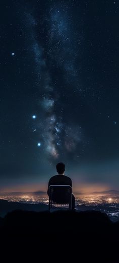 a person sitting on a bench looking at the stars