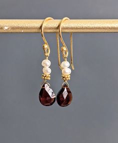 "Tiny Pearl, Garnet Drop Earrings 24 K Gold Filled Sterling Silver Vermeil Dangle Earrings, Wedding Jewelry, January & June Birthstone. The gold Vermeil hook earrings bring the total length of these stunners to 1 1/3\" ( 33 mm) long. * Processing time is 3 - 5 days.  * US orders are shipped first class mail. * International orders are shipped first class international. * Shipping upgrades are available at checkout. Thank you for visiting my listing! Have a wonderful day!" Faceted Drop Earrings For Wedding, Elegant Faceted Teardrop Dangle Earrings, Elegant Faceted Dangle Teardrop Earrings, Silver Garnet Dangle Earrings, Red Garnet Dangle Earrings, Silver 14k Gold-filled Pearl Drop Earrings, 14k Gold-filled Dangle Earrings With Pearl Charm, Garnet Drop Earrings, Hypoallergenic 14k Gold-filled Dangle Pearl Earrings