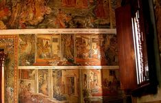 an ornately decorated room with many paintings on the wall