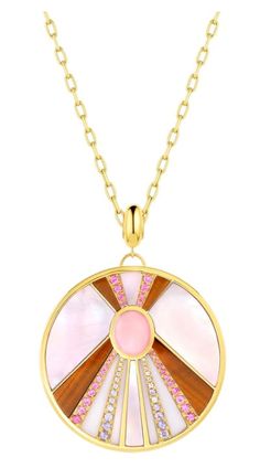 Our 18K Sun Stone Pendant Necklace is a new standout piece that feels vintage yet modern and sophisticated at the same time. Inspired by Cher's performances from the 70's, this necklace is a tribute piece. Handcrafted in rich 18k gold, this necklace features beautiful stonework set around a center opal. Rows of pave set gemstones accent the stonework and enhance the center cabochon. This necklace is offered in two colorways; blue which includes turquoise, lapis, gray mother of pearl, opals, and Sun Stone, Gold Sun, Stone Pendant Necklace, Stunning Jewellery, Pink Opal, Stone Pendant, Pink Sapphire, Stone Pendants, Blue Sapphire