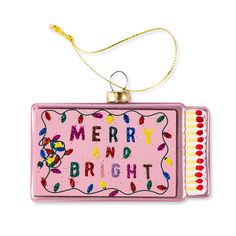 a pink christmas ornament with the words merry and bright on it