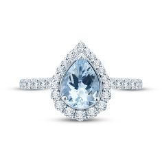 an engagement ring with a pear shaped aqua blue topazte surrounded by white diamonds