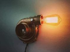 a light that is on the wall with a camera attached to it's side