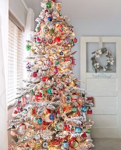 a white christmas tree with ornaments on it