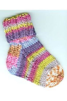 a multicolored knitted sock laying on top of a white surface