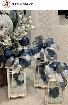 two white and blue lanterns with bows on them