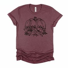 Botanical Pumpkin Graphic tee that shows a pumpkin filled with beautiful fall flowers. This soft and comfortable t-shirt will become your go-to tee for Fall! This is the perfect tee for styling with a dress or skirt just as often as you style it with your favorite jeans. Material: 52% Airlume Combed and Ringspun Cotton + 48% Polyester Care: Wash inside out on delicate with cold water. Hang to dry, or tumble dry on low. Cool iron if needed. Do not iron directly on the design. Sizing: This t-shirt