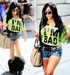 two women walking down the street wearing matching t - shirts that say i'm bad