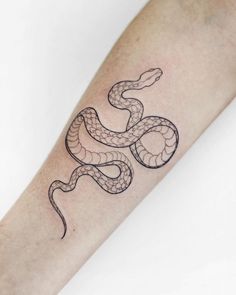 a black and white snake tattoo on the right arm, with an outline in the middle