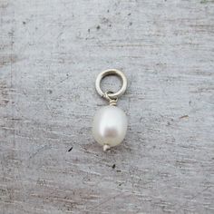 Genuine, Natural White to Off White Pearl CharmChoose these pearl charms to add to your existing necklaces or bracelets. Each charm comes with a large enough jump ring which is wide enough to slide onto most existing chains.Each bead is approximately 6mm wide and 8mm tall, size varies slightly.The color of these natural pearls varies slightly from white to slightly off white.Choose from the following findings:Solid .925 Sterling Silver Wire and Jump RingSolid 14 Karat Yellow Gold, Rose Gold or W White Pearl Pendant Charms, White Pearl Jewelry With Charms, Figaro Necklace, Rose Gold Pearl, Printed Jewelry, Pearl Charms, Gold Pearl, Natural Pearls, Gold Gold