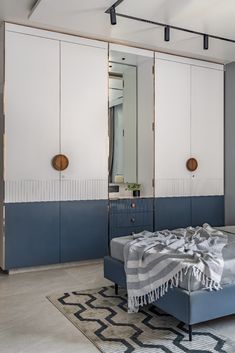 a bedroom with blue and white furniture in it