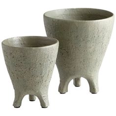 two white planters sitting next to each other